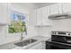 Updated kitchen featuring white cabinets and granite countertops at 3563 Bolfair Nw Dr, Atlanta, GA 30331