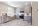 Modern kitchen with gray cabinets, stainless steel appliances, and quartz countertops at 3790 Jack Vernon Cir, Powder Springs, GA 30127