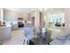 Open concept kitchen and dining area with gray cabinets and glass dining table at 3790 Jack Vernon Cir, Powder Springs, GA 30127