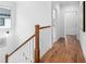 Upstairs hallway with hardwood floors and wooden railing at 971 Boulevard # B, Atlanta, GA 30312