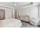 Bright main bedroom features a ceiling fan, dresser, chair, and ensuite bathroom at 3827 Cottage Cir, Tucker, GA 30021