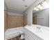 Bathroom with white vanity, tiled tub, and grey paint at 7018 Chimney Ridge Dr, Riverdale, GA 30296