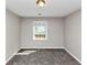 Cozy bedroom featuring plush carpet, neutral paint, and a bright window offering natural light at 7018 Chimney Ridge Dr, Riverdale, GA 30296