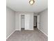 Neutral bedroom featuring a closet with shutter doors, neutral walls, and carpeted floors at 7018 Chimney Ridge Dr, Riverdale, GA 30296