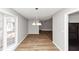 Dining area with wood flooring, window with blinds, and a chandelier at 7018 Chimney Ridge Dr, Riverdale, GA 30296