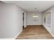 Bright dining room features wood floors, light gray walls, and a chandelier over the table area at 7018 Chimney Ridge Dr, Riverdale, GA 30296