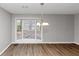 Dining area with wood flooring, a bay window with blinds, and a chandelier at 7018 Chimney Ridge Dr, Riverdale, GA 30296