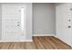 Bright entryway featuring a front door with sidelight and modern flooring at 7018 Chimney Ridge Dr, Riverdale, GA 30296