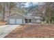 Charming single-story home with a two-car garage and inviting curb appeal in a wooded setting at 7018 Chimney Ridge Dr, Riverdale, GA 30296
