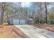 View of the home's driveway leading up to the two-car garage and charming front entrance at 7018 Chimney Ridge Dr, Riverdale, GA 30296