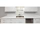 Kitchen featuring white cabinets, light countertops, and stainless steel dishwasher at 7018 Chimney Ridge Dr, Riverdale, GA 30296