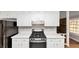Kitchen with white cabinets, light countertops, stainless steel oven and cooktop at 7018 Chimney Ridge Dr, Riverdale, GA 30296