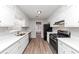 Galley style kitchen features white cabinets, light countertops, and stainless steel appliances at 7018 Chimney Ridge Dr, Riverdale, GA 30296