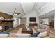 Bright living room with a vaulted ceiling, stone fireplace, and comfortable seating area at 7018 Chimney Ridge Dr, Riverdale, GA 30296