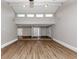Open-concept living room featuring vaulted ceiling, modern flooring and bright lighting at 7018 Chimney Ridge Dr, Riverdale, GA 30296