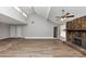 Bright living room with vaulted ceilings, a stone fireplace, and access to other rooms at 7018 Chimney Ridge Dr, Riverdale, GA 30296