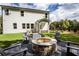 Inviting backyard with stone fire pit, chairs, and a charming two-story home at 319 Willam Gossett Dr, Canton, GA 30114