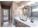 Bathroom view featuring double vanity sinks, with marble floors, and a glass-enclosed shower at 319 Willam Gossett Dr, Canton, GA 30114