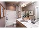Bathroom featuring a double vanity, large mirror, and a shower with a glass door at 319 Willam Gossett Dr, Canton, GA 30114