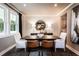 Dining room with ample light, a dark wood table, stylish decor, and a view into the kitchen at 319 Willam Gossett Dr, Canton, GA 30114