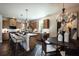 Bright kitchen showcases wood cabinets, a large center island, and an adjacent dining area with chandelier at 319 Willam Gossett Dr, Canton, GA 30114