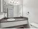 Bathroom with a dark countertop vanity, large mirror, and decorative lighting at 6806 Glenridge Dr # E, Atlanta, GA 30328
