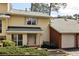 Charming townhouse featuring yellow siding, a brick facade and an attached single car garage at 6806 Glenridge Dr # E, Atlanta, GA 30328