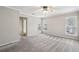 Carpeted main bedroom with neutral paint, a ceiling fan, and windows for ample light at 6806 Glenridge Dr # E, Atlanta, GA 30328