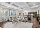 Open-concept living room featuring hardwood floors, a coffered ceiling, and plenty of natural light at 821 Ethereow Ct, Lawrenceville, GA 30046