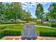 Outdoor memorial park featuring a granite monument with inscriptions surrounded by landscaping at 121 Meridian Dr, Woodstock, GA 30188