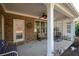 Covered back porch with ceiling fan and seating area at 121 Meridian Dr, Woodstock, GA 30188