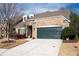 Brick home with dark green garage door and landscaping at 121 Meridian Dr, Woodstock, GA 30188