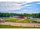 Outdoor stage and grassy amphitheater under a bright sky, surrounded by lush greenery at 121 Meridian Dr, Woodstock, GA 30188