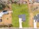 An aerial view of a home showcasing its expansive, well-maintained lawn and fenced backyard at 3 Derrick Ave, Hampton, GA 30228