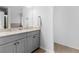 Bathroom featuring a gray double vanity with granite countertops and modern mirrors at 3 Derrick Ave, Hampton, GA 30228