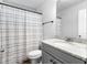 Modern bathroom featuring a granite countertop vanity and striped shower curtain at 3 Derrick Ave, Hampton, GA 30228