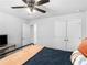 Comfortable bedroom featuring a closet, a TV, and a bed with decorative pillows and a blanket at 3 Derrick Ave, Hampton, GA 30228