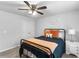Cozy bedroom featuring a ceiling fan, comfortable bed with decorative pillows, and a nightstand with a lamp at 3 Derrick Ave, Hampton, GA 30228