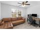 Spare bedroom with a large window, ceiling fan, and leather couch at 3 Derrick Ave, Hampton, GA 30228