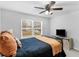 Bedroom featuring a TV, a cozy bed with pillows and a blanket, and a window at 3 Derrick Ave, Hampton, GA 30228