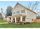 Attractive home showcasing a covered front porch with rocking chairs and a manicured lawn at 3 Derrick Ave, Hampton, GA 30228