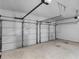 Spacious two-car garage with white doors and concrete flooring at 3 Derrick Ave, Hampton, GA 30228