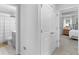Upstairs hallway has a linen closet and a view into the main bedroom and bathroom at 3 Derrick Ave, Hampton, GA 30228