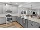 Modern kitchen with stainless appliances, granite countertops, and gray cabinetry at 3 Derrick Ave, Hampton, GA 30228