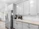 Well-lit kitchen featuring stainless steel appliances, hard surface countertops, and gray cabinetry at 3 Derrick Ave, Hampton, GA 30228