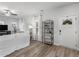 Bright living room with hardwood floors, front door, modern shelving, and neutral decor at 3 Derrick Ave, Hampton, GA 30228