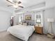 Bright main bedroom with tray ceilings, fan, and comfortable bed with accent pillows at 3 Derrick Ave, Hampton, GA 30228
