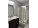 Bathroom with dark vanity, granite countertop, and walk-in shower at 1345 Keys Crossing Ne Dr # 1345, Atlanta, GA 30319