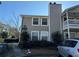 Two-story condo building with gray siding, balconies, and parking at 1345 Keys Crossing Ne Dr # 1345, Atlanta, GA 30319