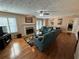 Spacious living room with hardwood floors, fireplace, and teal couch at 1345 Keys Crossing Ne Dr # 1345, Atlanta, GA 30319